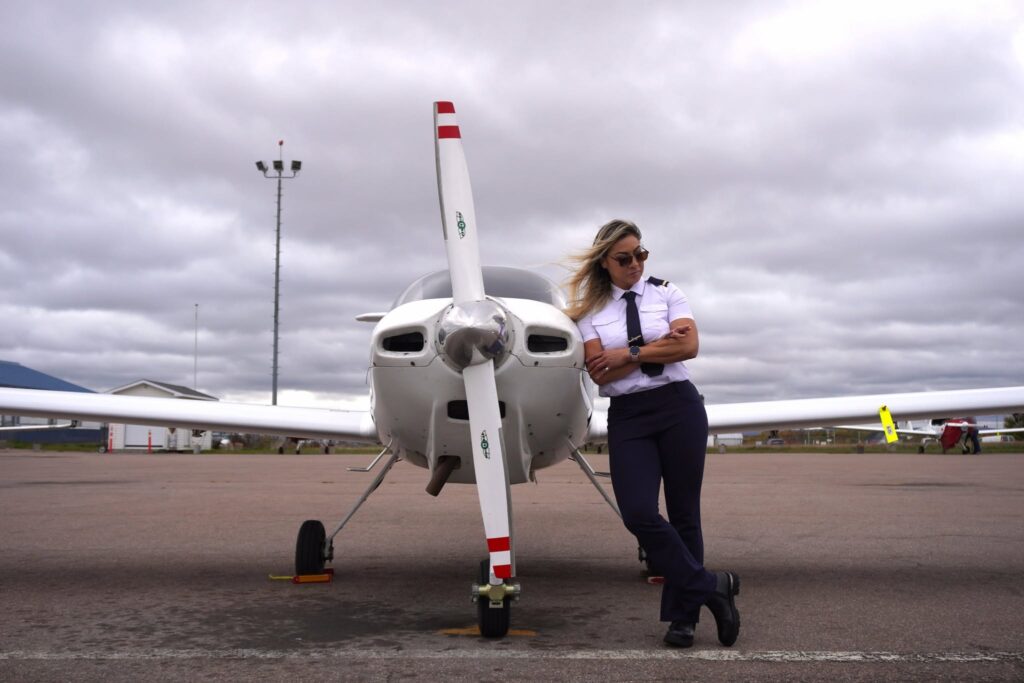 Pilot Leaning on Plane